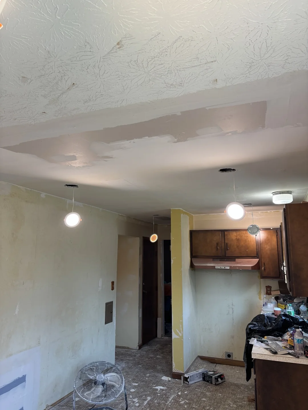 Kitchen ceiling patching and smoothing with LED light fittings being installed.