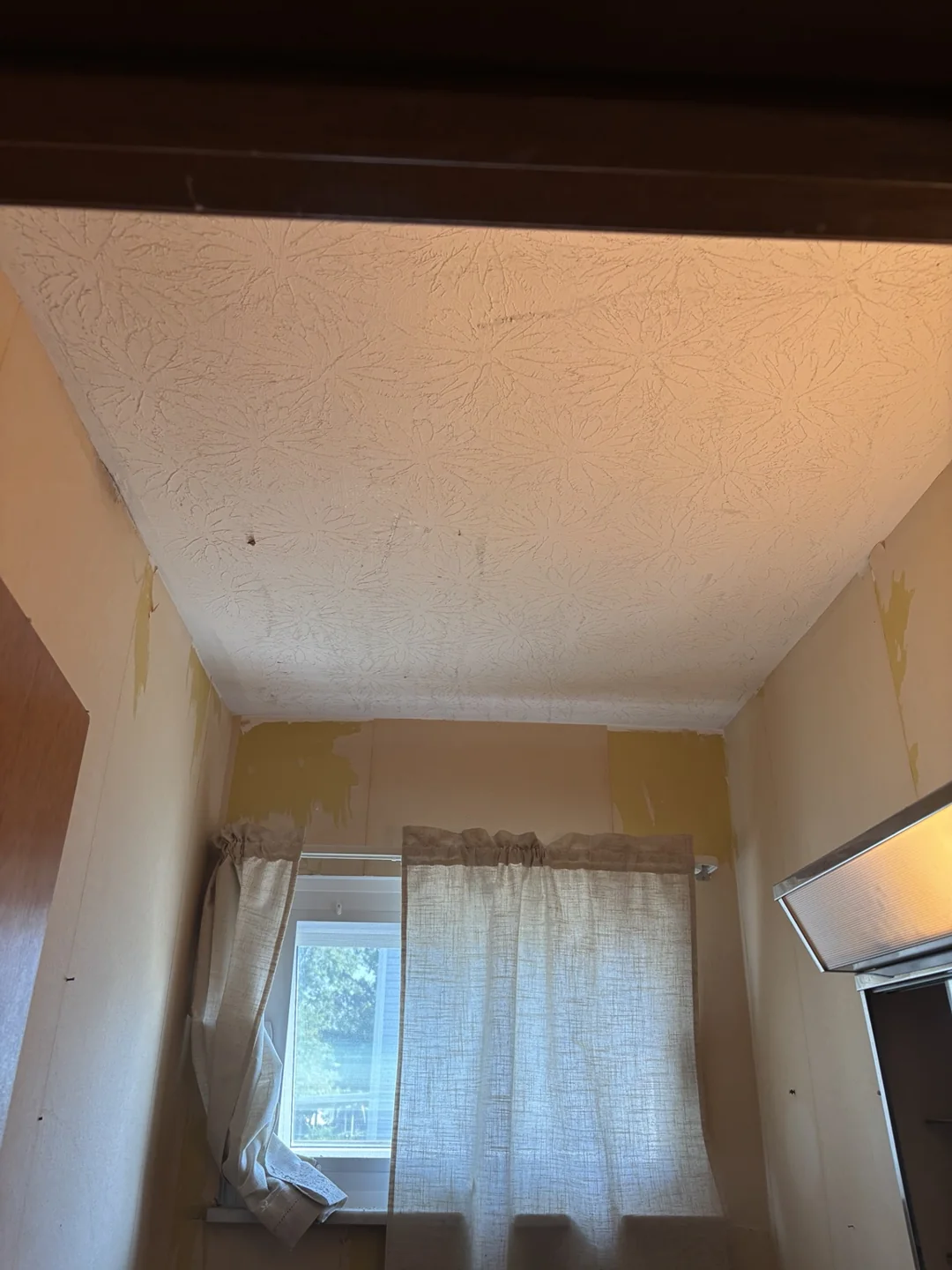 Textured kitchen ceiling before the flat ceiling renovation.