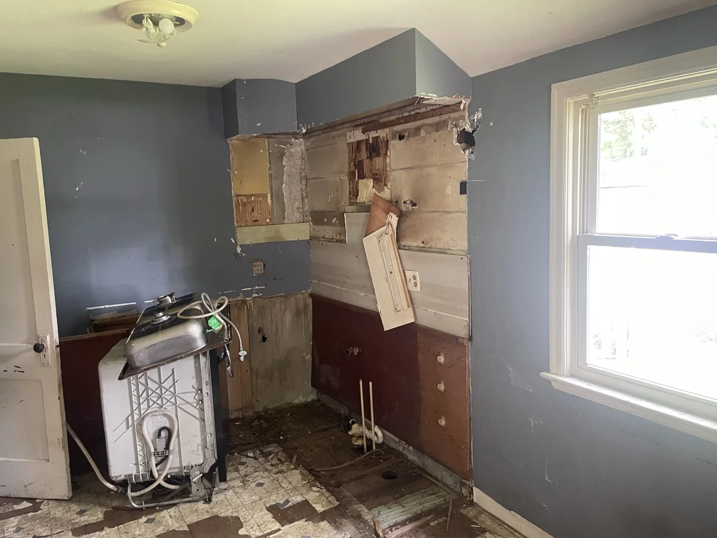 Kitchen corner after removal of cabinets and sink, before new installation.