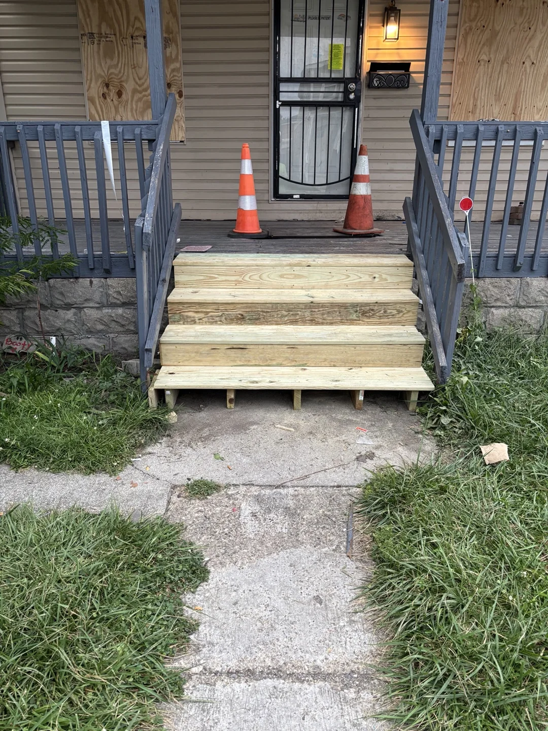 Replacement wooden stair treads installed at the front porch.