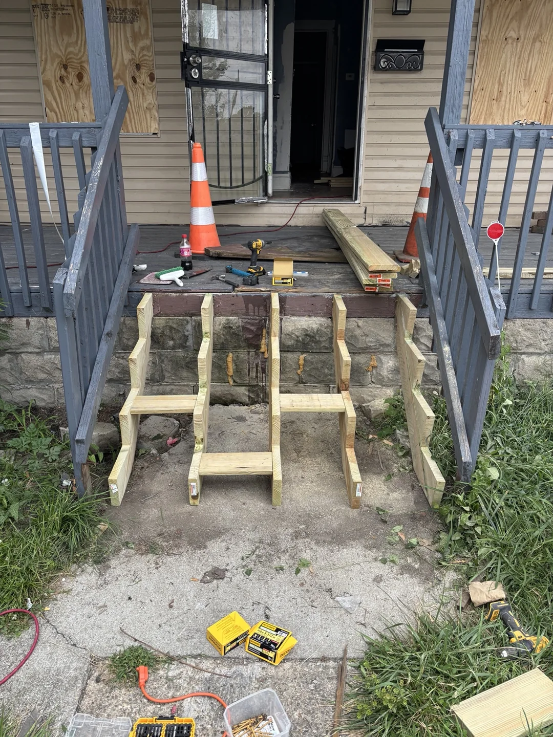 New stair framing in place with the old treads removed during porch repairs.
