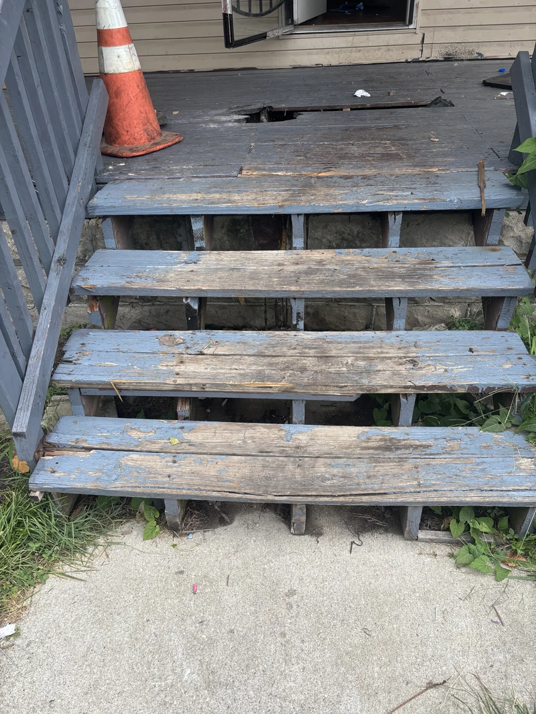 Existing weathered porch steps before replacement work.