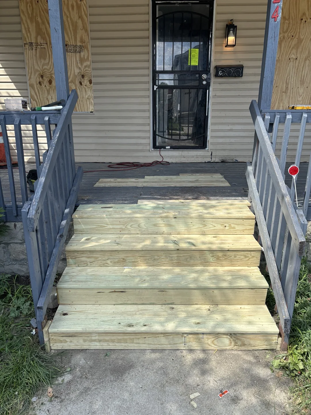 Front view of the porch steps with new wooden treads installed.